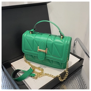 Detail of lime green quilted handbag with geometric patterns and gold metal clasp