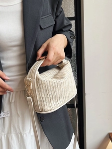 Handmade woven straw tote bag with cream leather trim and gold metal strap connectors