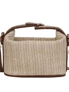 Chic woven straw crossbody bag with brown leather handles and gold metal clasp on white background