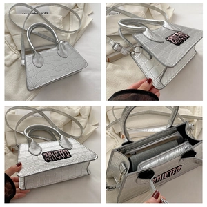 Detailed views of silver crocodile texture handbag with AMIEBO embroidery and interior pockets