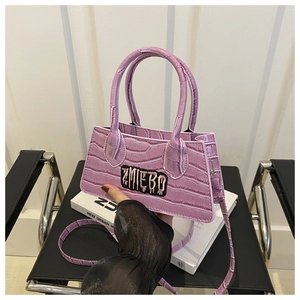 Detail of purple crocodile-patterned small square bag with ZMIEBO embroidered logo
