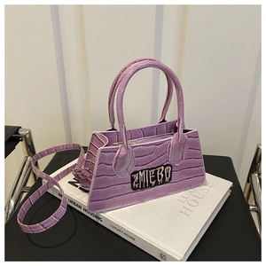 Detail of purple faux crocodile texture crossbody bag with silver zipper and logo patch