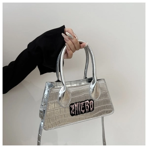 Detail of silver crocodile-patterned leather mini bag with pink graffiti embroidery