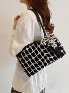 Contrast tweed tote bag with decorative silk scarf on model for commuting