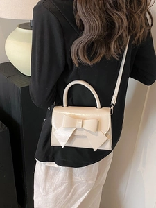 Chic cream bow shoulder bag for women, versatile cross-body purse with a circular handle