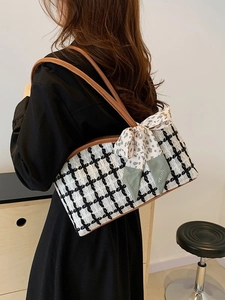 Contrast tweed tote bag with bow detail and brown leather straps shown from a side view