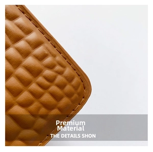 Close-up of brown crocodile pattern faux leather with precise stitching details
