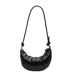 Classic black croissant bag with knotted shoulder strap and crescent quilted design