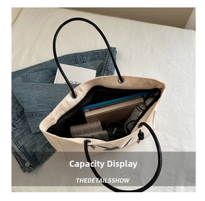 Detail showing the spacious interior of this star print nylon tote bag with daily essentials