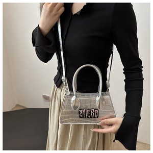 Silver crocodile texture mini bag with pink ZMIEBO lettering and adjustable strap