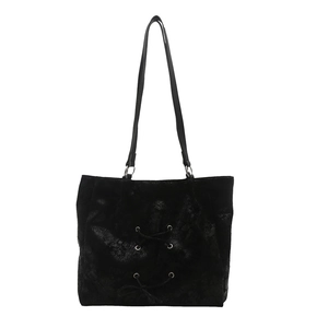 Fashionable black bow-accented tote bag with vintage texture and metallic eyelet details