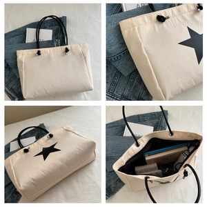 Detail view of large star print tote bag with thick cord handles and spacious interior