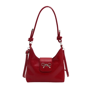 Retro red faux leather underarm bag with a decorative silver bow and adjustable strap