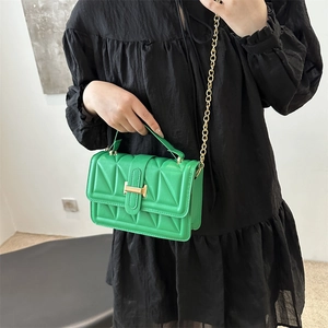Green quilted mini square bag with gold H-buckle and chain strap shown on model