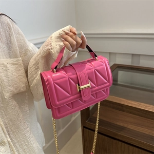 Modern magenta quilted crossbody bag with gold rectangular clasp and chain strap