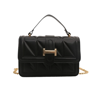 Elegant black quilted small square crossbody bag with gold hardware and top handle