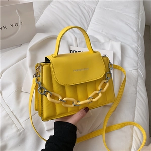 Bright yellow quilted PU leather crossbody bag with decorative chain and top handle