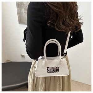 Chic white crocodile pattern small crossbody bag with stylish embroidery detail on model