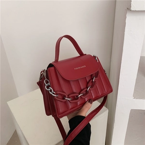 Detail of burgundy quilted leather bag with silver chain and Fashion & Bags text