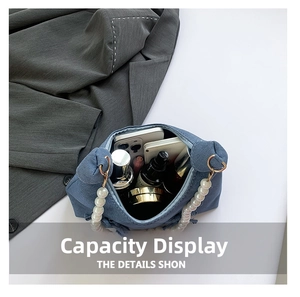 Interior view of denim shoulder bag showing large capacity with pearls handle detail