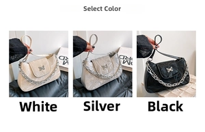 Detailed view of glossy underarm bags in white, silver, and black with chain and butterfly buckle