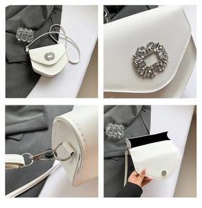 Détail du sac bandoulière blanc en similicuir avec boucle en strass et garnitures argentées