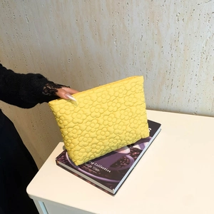 Quilted floral embroidered cosmetic bag in vibrant yellow with a minimalist square design