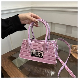 Detail of lavender crocodile texture bag with ZMIEBO embroidery and stylish handle