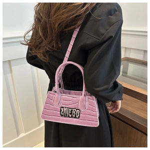 Detailed back view of pink crocodile embossed mini handbag with ZMIEBO letter decoration