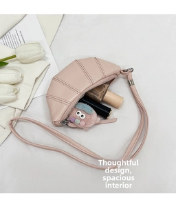 Detailed interior of a pink leather crossbody croissant bag showing compact storage space