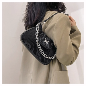 Detail of black marble pattern PU leather underarm bag with metal butterfly and chain