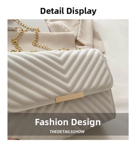 Detail of white V-quilted texture with gold chain strap and luxury metal clasp