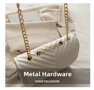 Detail of white V-quilted faux leather crossbody bag with polished gold chain strap