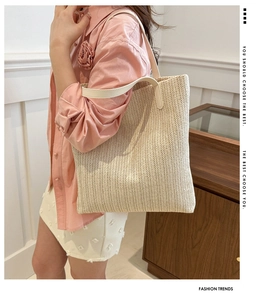 Close-up of woven straw tote bag with ivory PU leather strap and large capacity