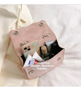 Detail view of pink crossbody bag interior showing spacious storage for phone and cosmetics
