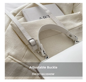 Close-up of white woven bag showing adjustable silver metal buckle and handle detail