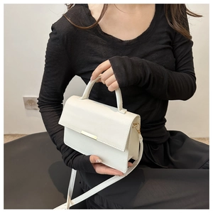 Chic cream small square shoulder bag with gold metal trim and stylish top handle detail