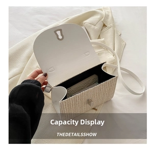 Interior view showing the capacity of the white woven flap bag with silver lock and strap
