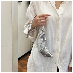 Detail of silver metallic croissant bag with pleated seams and zipper closure
