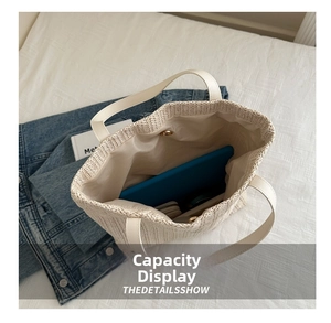 Detail of the woven tote bag featuring a magnetic clasp and spacious interior for a tablet
