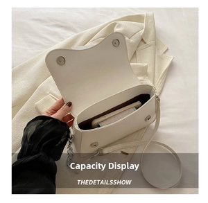 Internal view of a white crossbody bag showing storage capacity for a smartphone