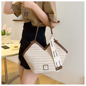 Detail of straw tote bag with V-shaped opening and sport fashion logo on beige woven texture