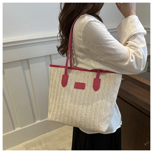 Detail of hand-woven tote bag in cream white with hot pink contrast trim on shoulder