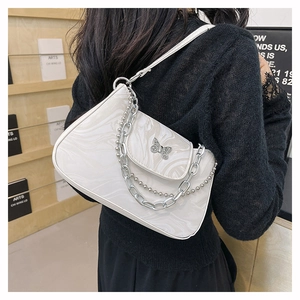 Detail of white marble pattern underarm bag with silver butterfly emblem and metal chain