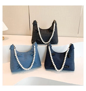 Detailed trio of denim crescent bags with pearl chain straps and ribbon bow accents