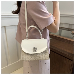 Detail of white leather and straw woven crossbody bag with silver keyhole lock