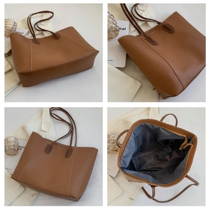 Detail of a brown tote bag showing the zipper closure and spacious interior lining