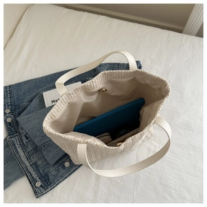 Top view of woven tote bag interior showing spacious capacity for tablets and wallets
