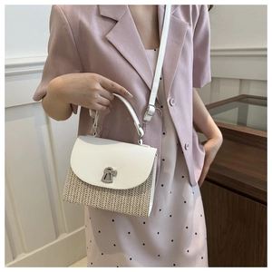 Fashionable woven straw crossbody bag with white leather flap and silver clasp closure