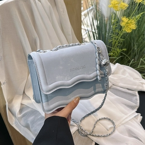 Chic light blue chain crossbody bag with wave edge flap and metallic sphere pendant